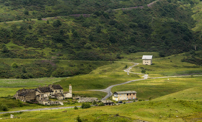 Fototapeta na wymiar Amazing view with old buildings near Lanslebourg-Mont-Cenis (Savoie, Auvergne-Rhone-Alps),Col du Mont Cenis who connects Val Cenis in France in the northwest with Susa in Italy in southeast.