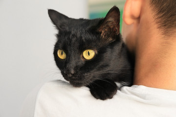 Man holding black cat. Adoption concept