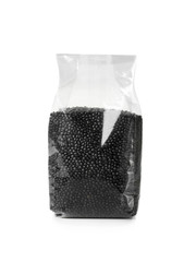 Plastic package with black lentils on white background