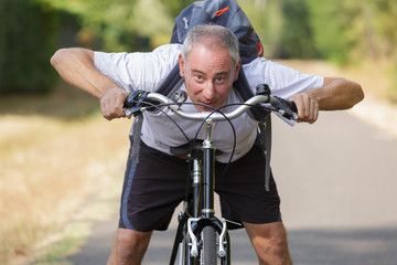 Obraz premium cheerful middle aged man on a bike outdoors