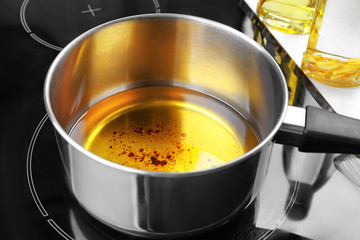 Saucepan with used vegetable oil on stove