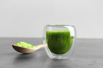 Wheat grass shot on grey table