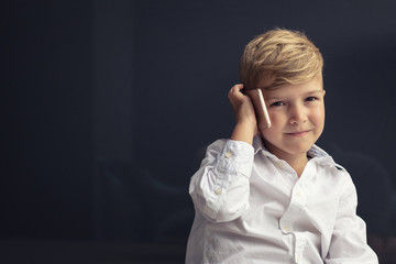 Blond boy talking on mobile phone.