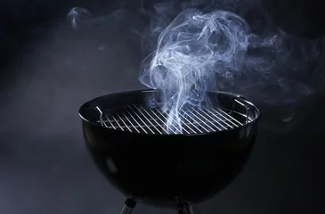 Selbstklebende Fototapeten Barbecue grill on dark background © Africa Studio