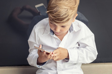 Child playing games on smart phone.