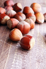 Fototapeta premium Hazelnut on wooden background. Tasty group of organic hazelnuts