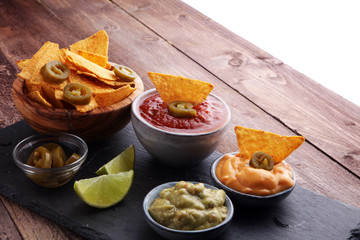 Nachos Tortilla Chips and jalapeÒos Chili Peppers or Mexican chili peppers with Tomato, Cheese and Guacamole dip