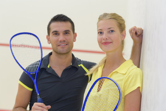 young cheerful couple after playing badminton