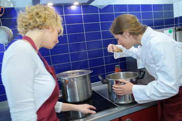 Chef tasting from saucepan