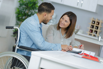 loving girl with her boyfriend in wheelchair