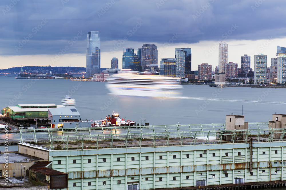 Wall mural a cruise ship in motion on hudson river between new york city and new jersey