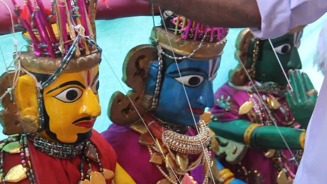 Pan left to right across traditional marionette puppets