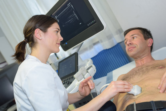 man being checked with ultrasound device in a hospital
