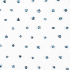 Blueberries on white background. Food blog or magazine concept texture.