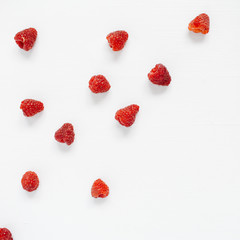 Raspberries on white background. Food blog or magazine concept texture.