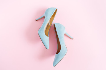 Fashion blog look. Pastel blue women high heel shoes on pink background. Flat lay, top view trendy...