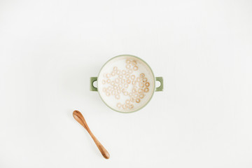 Cereals with milk on white background. Flat lay, top view.
