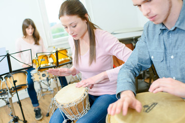 youg girl learning to play the drums