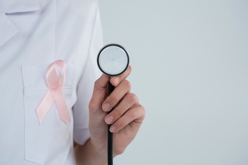 Female doctor with  Breast Cancer Awareness ribbon holding