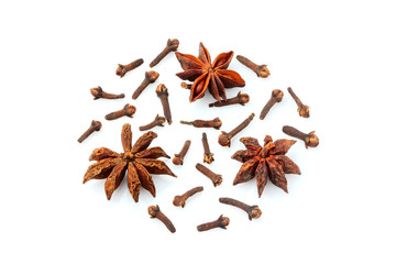 Star Anise and cloves scattered isolated.