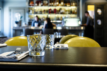 Beautiful glasses for water and Cutlery are on the table in the restaurant, waiting for the guests.