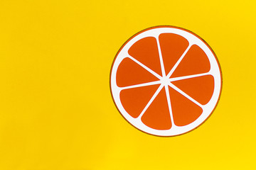 Isolated Painted orange fruit on a yellow background