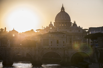 Obraz premium Rome, Italy.Vatican dome of Saint Peter Basilica (San Pietro) and Sant'Angelo Bridge, over Tiber river at sunset. One of the most famous view in the World. One of the most famous view in the World