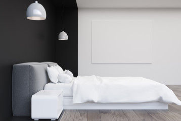Black and white bedroom with a poster