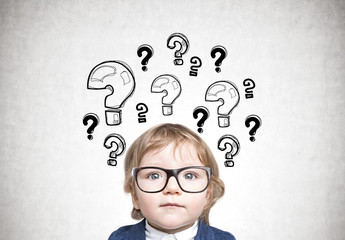 Cute baby boy in glasses, many questions