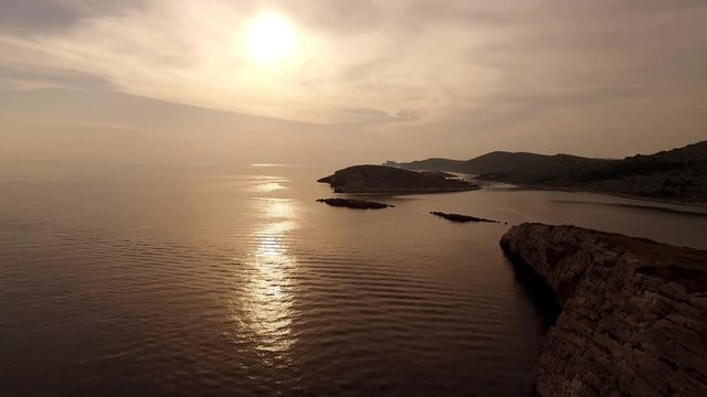 Aerial view of sunset over Adriatic sea in Croatia with seagulls flying around