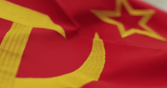 Soviet Russia flag detail with embroidered hammer and sickle as the symbol of communism.