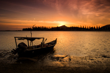 scenery of sunset at Lumut,Perak,Malaysia. Soft focus,motion blur due to long exposure.Visible Noise due to high ISO.