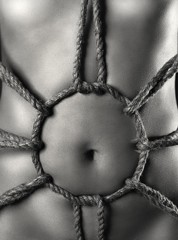 Woman's stomach with artistic rope pattern of Japanese bondage Shibari