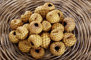 Rumbia, dried Salak fruit (Salacca zalacca) in a woven basket