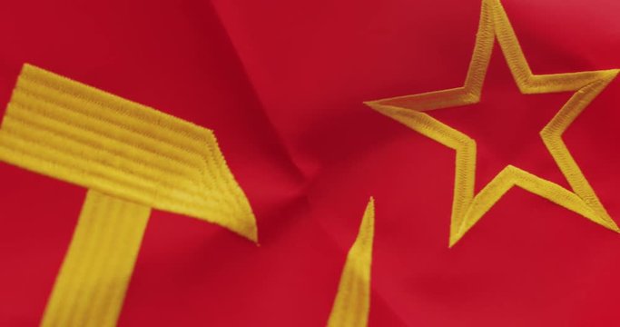 Soviet Russia flag detail with embroidered hammer and sickle as the symbol of communism.