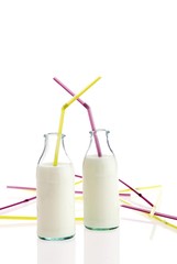 Milk in bottles with straws