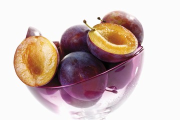 Glass bowl with plums, prunes