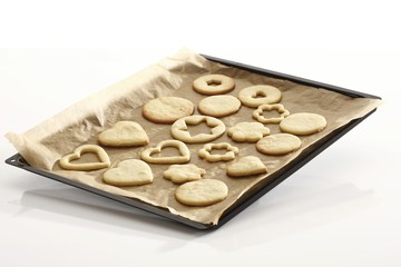 Shortcrust cookies on baking tray, baking for Christmas