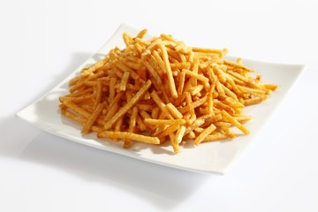 Potato sticks on porcelain plate