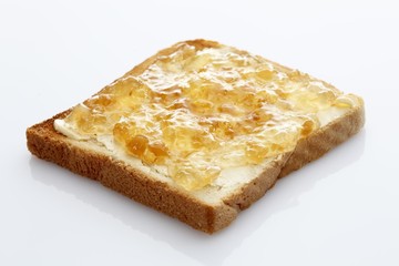 Slice of toast, toasted slice of bread, with ginger jam