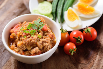 Northern Thai food (Nam Prik Ong) with vegetables on wooden background,spicy tomato with pork,red chili dip,Northern Thai dipping sauce