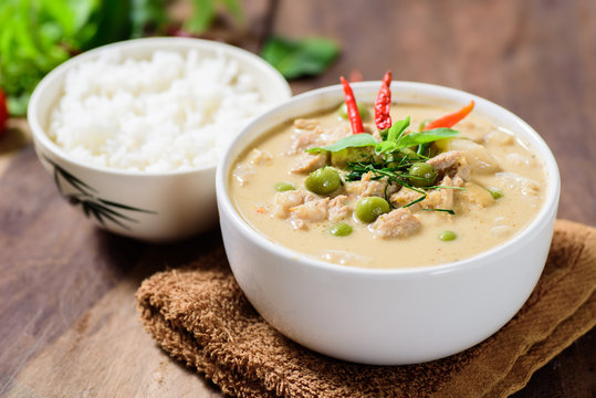Thai food (Panaeng curry),red curry with pork and cooked rice in a bowl on wooden background