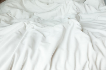 Obraz premium Top view of white bedding sheets after wake up in the morning