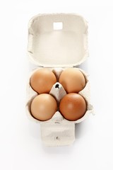 Four eggs in a cardboard box
