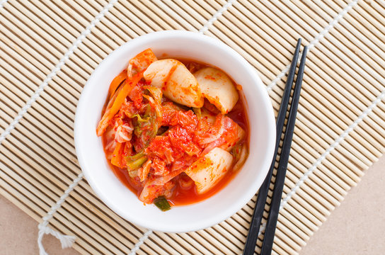 Korean food,kimchi cabbage in a bowl with chopsticks for eating.Top view of food