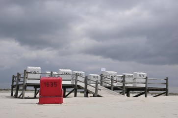 Roofed wicker beach chairs on a platform on stilts, beach on the North Sea, St. Peter-Ording, Schleswig-Holstein, Germany, Europe