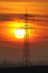 Electric power transmission lines, electricity pylon, with the setting sun, Beinstein near Stuttgart, Baden-Wuerttemberg, Germany, Europe