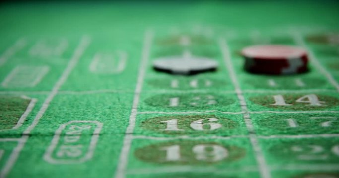 Casino chips on roulette on poker table 