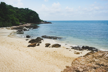 Fototapeta na wymiar Tropical beach view with sand rock and ocean