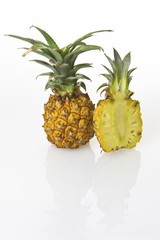 Two Pineapples (Ananas comosus), one cut in half